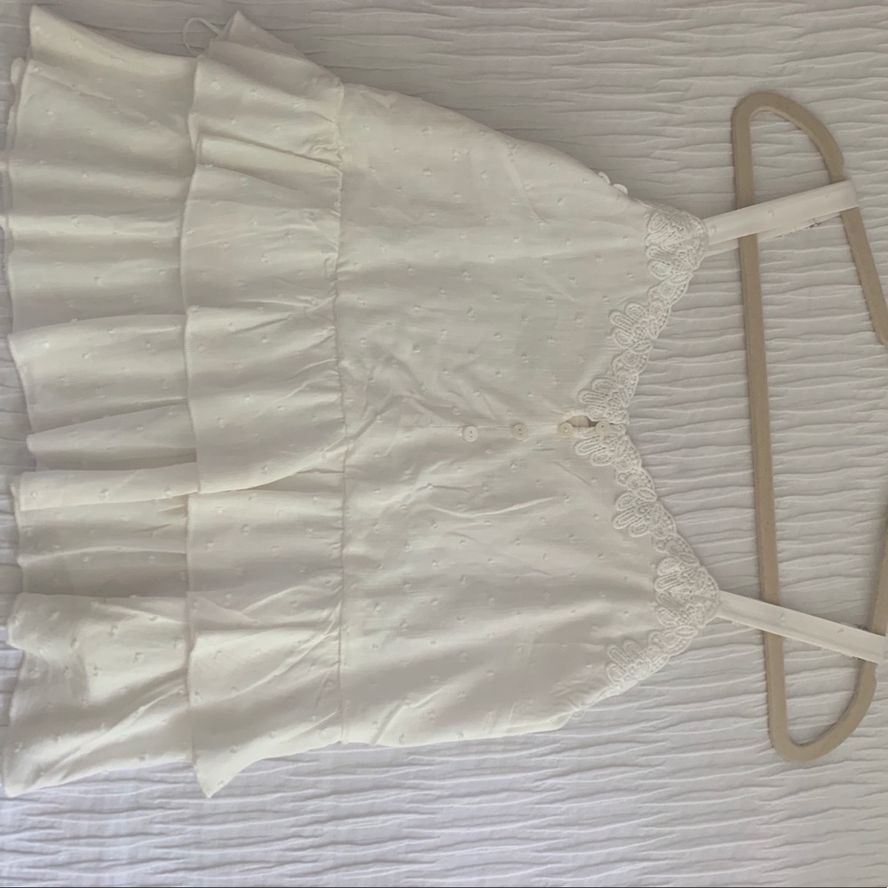 White blouse with some buttons.